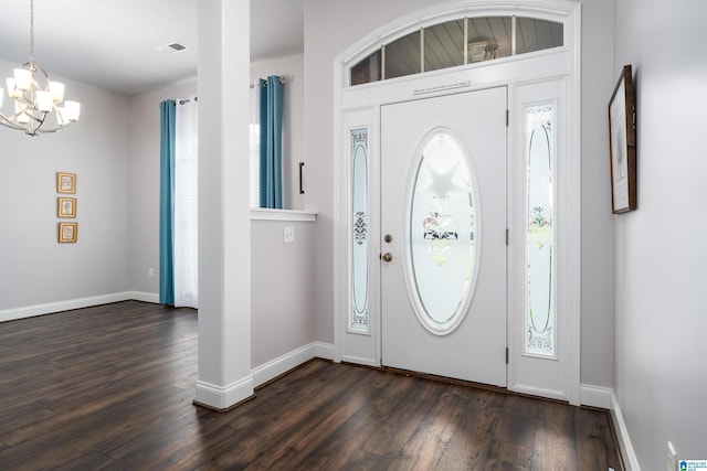 foyer with a notable chandelier and dark hardwood / wood-style floors