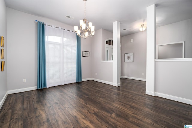 unfurnished room with dark hardwood / wood-style floors and a chandelier