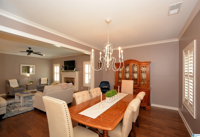 dining area with ornamental molding, ceiling fan with notable chandelier, and dark hardwood / wood-style flooring