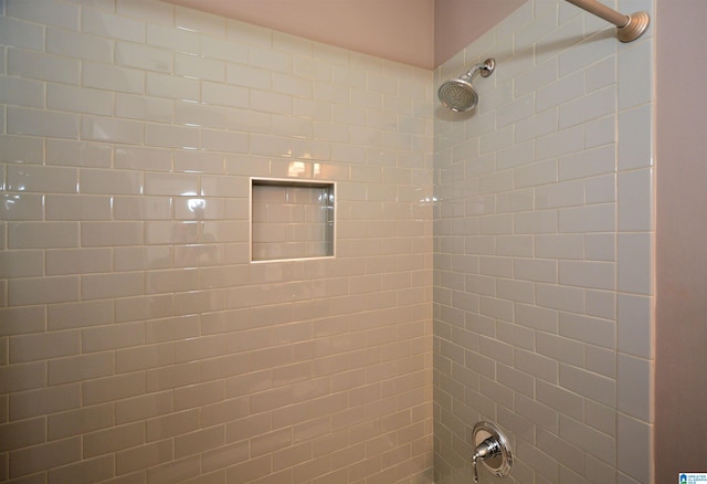 interior details with a tile shower