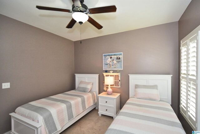 bedroom with ceiling fan and light colored carpet