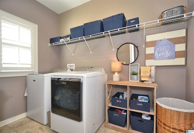 clothes washing area with light tile patterned floors and washing machine and clothes dryer