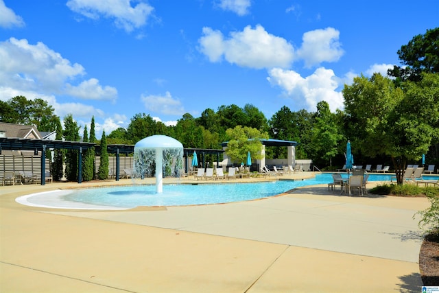 view of swimming pool featuring pool water feature, a patio, and a pergola