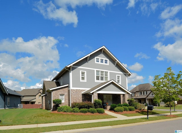 craftsman inspired home with a front lawn