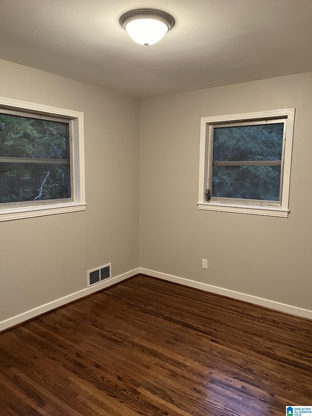 unfurnished room with dark hardwood / wood-style floors