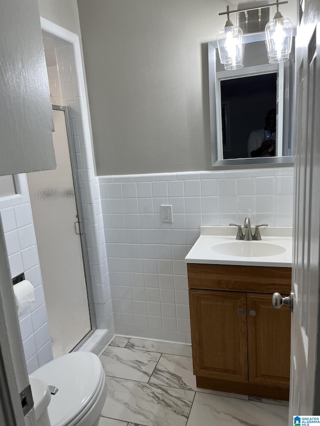 bathroom featuring vanity, an enclosed shower, backsplash, tile walls, and toilet