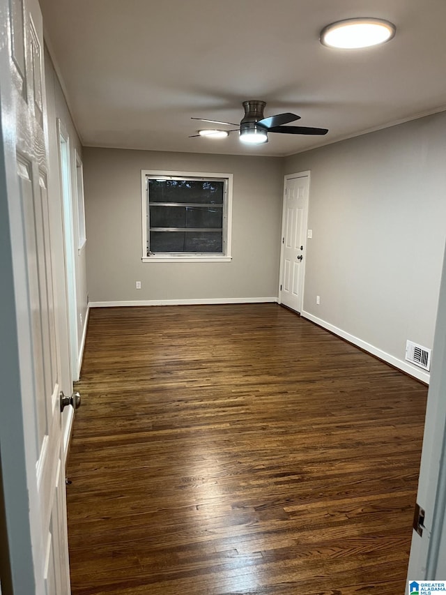 unfurnished room with dark wood-type flooring and ceiling fan