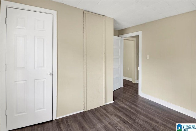 interior space with dark hardwood / wood-style floors and a closet