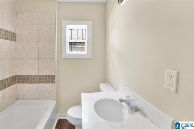 full bathroom with independent shower and bath, sink, hardwood / wood-style floors, and toilet