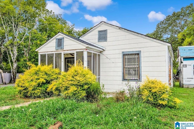 view of home's exterior with a sunroom