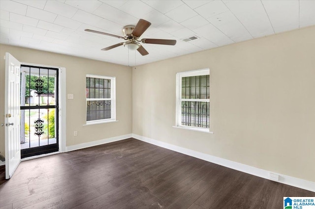 spare room featuring ceiling fan and dark hardwood / wood-style floors