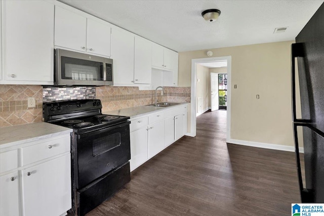 kitchen featuring black appliances, sink, dark wood-type flooring, and white cabinets