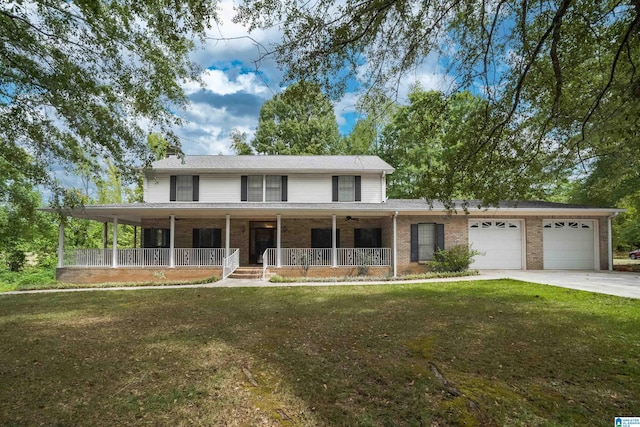 farmhouse-style home featuring a front yard, covered porch, and a garage