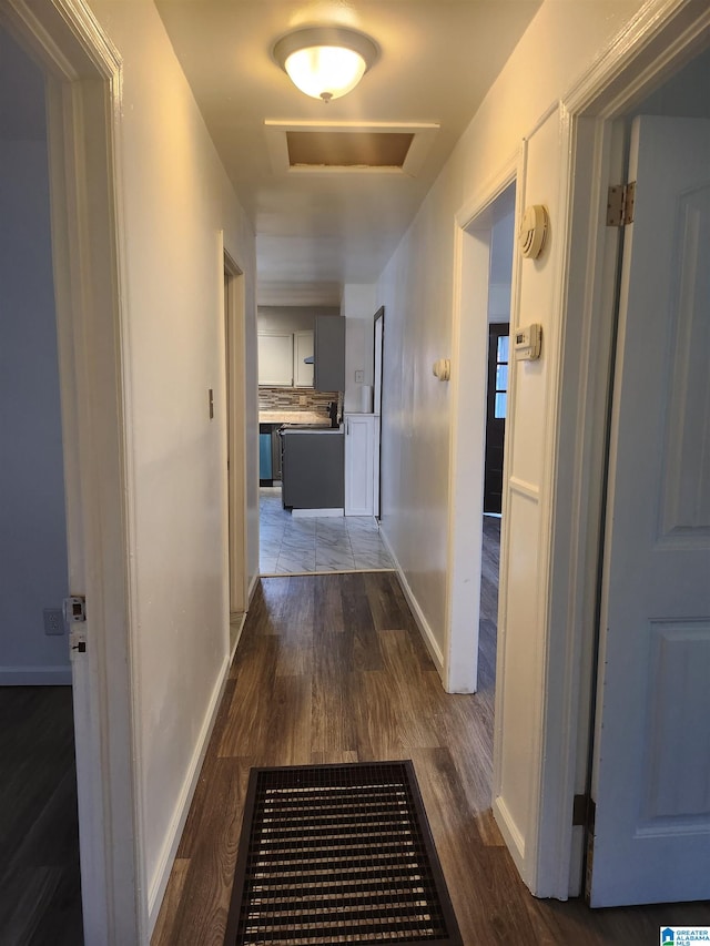 hallway with dark hardwood / wood-style floors