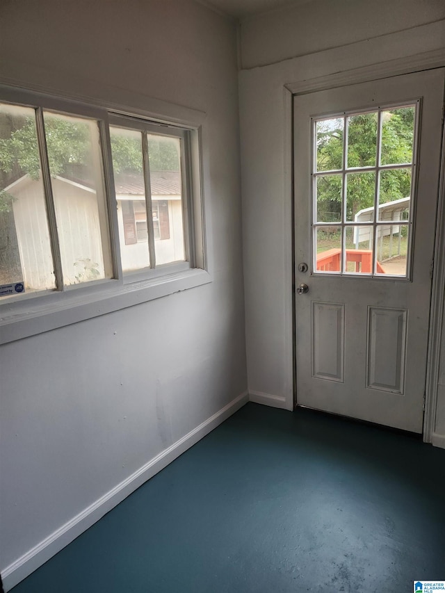 doorway to outside with concrete flooring