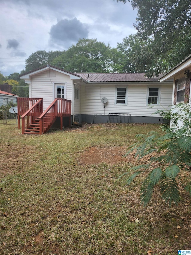 back of property featuring a lawn