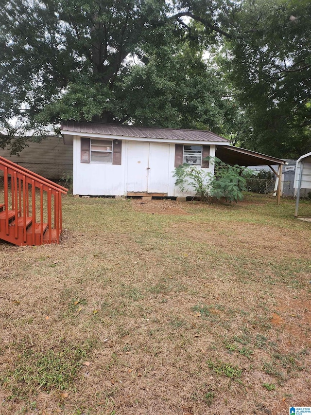 exterior space with a lawn and a carport