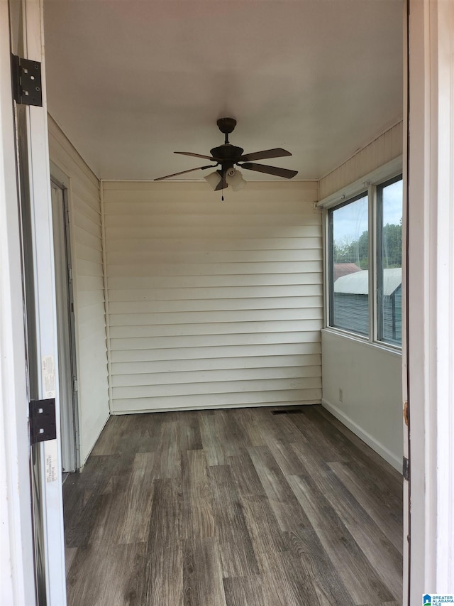 unfurnished sunroom featuring ceiling fan