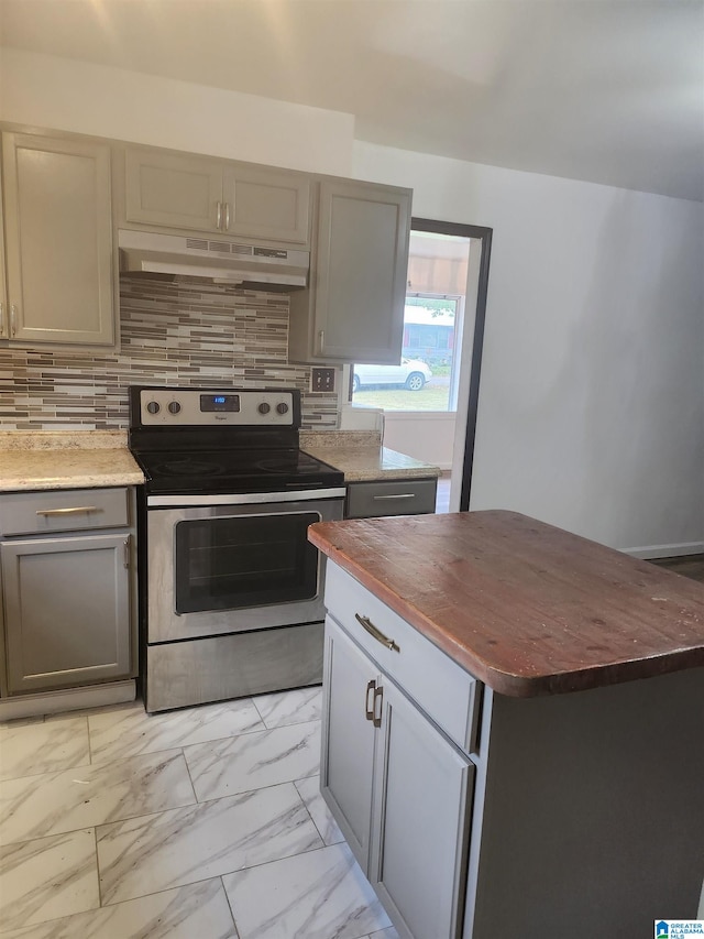 kitchen with gray cabinets, stainless steel electric stove, and backsplash