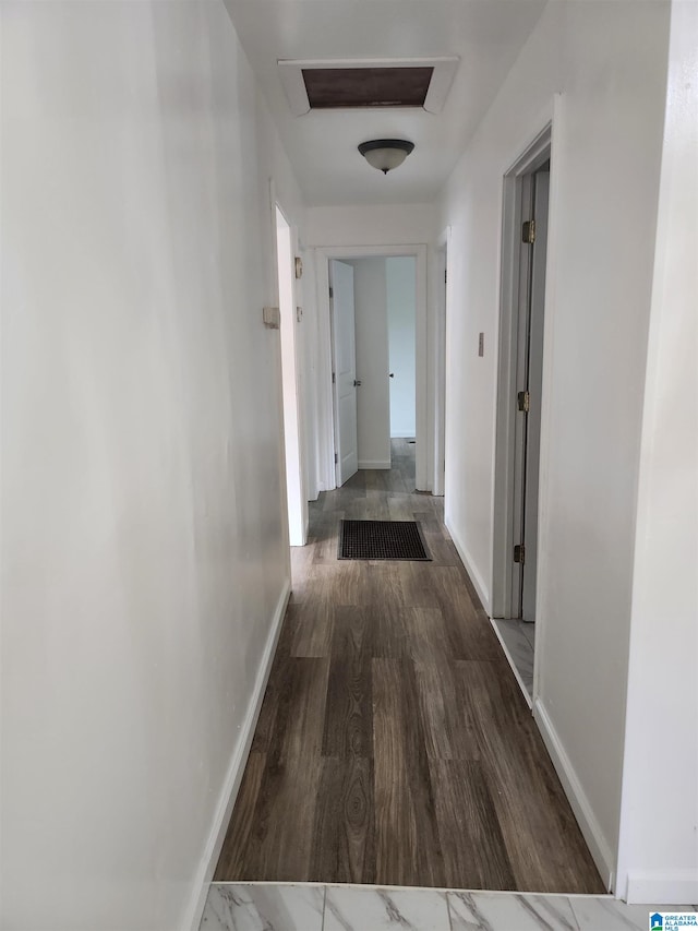 corridor featuring dark hardwood / wood-style floors