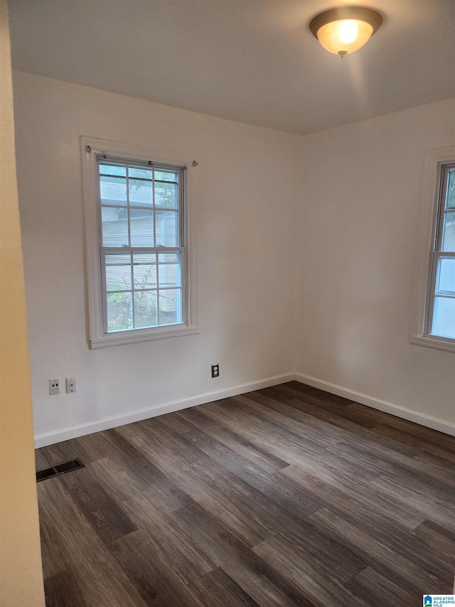 spare room with dark hardwood / wood-style flooring