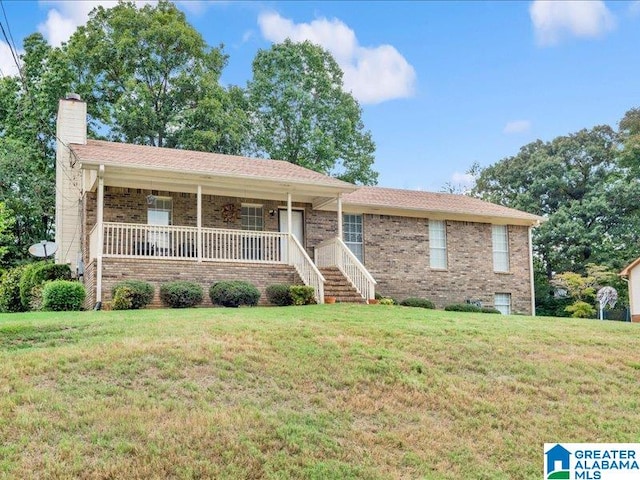 ranch-style house featuring a porch and a front yard