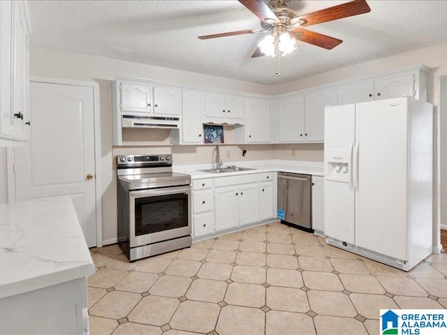 kitchen with a textured ceiling, stainless steel appliances, sink, white cabinetry, and ceiling fan