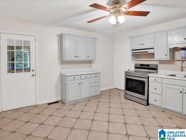 kitchen featuring electric stove, white cabinetry, a textured ceiling, sink, and ceiling fan