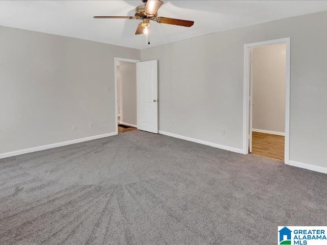 carpeted empty room featuring ceiling fan