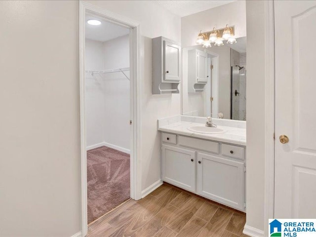 bathroom with vanity, hardwood / wood-style floors, and an enclosed shower