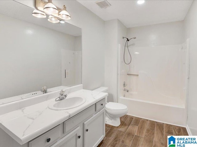 full bathroom with vanity, toilet, tub / shower combination, and wood-type flooring