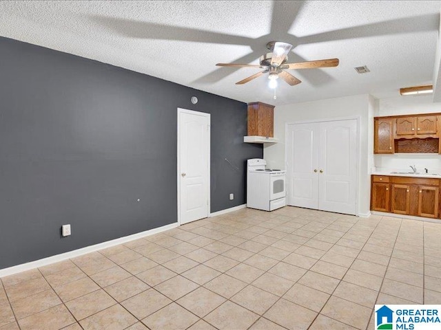 unfurnished living room with a textured ceiling, sink, and ceiling fan