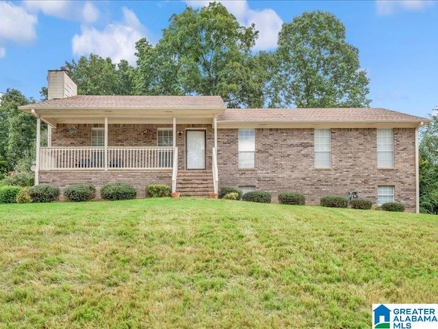 view of front of home featuring covered porch and a front lawn