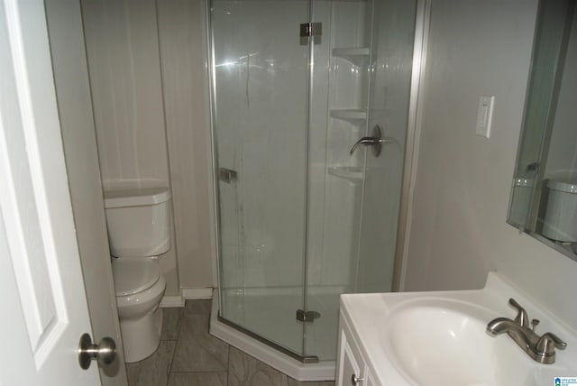 bathroom with vanity, toilet, and walk in shower