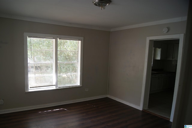 spare room with crown molding and dark hardwood / wood-style floors