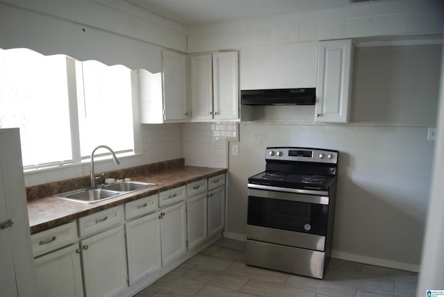 kitchen with electric range, sink, decorative backsplash, and white cabinetry