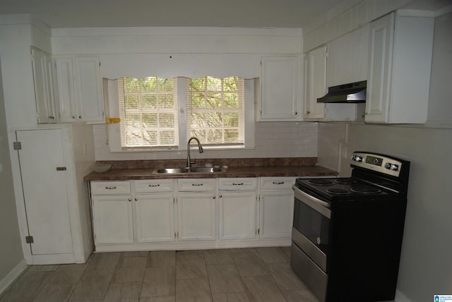 kitchen with stainless steel range with electric stovetop, white cabinetry, sink, and decorative backsplash