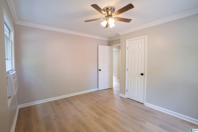 unfurnished room with ceiling fan, light hardwood / wood-style floors, and crown molding