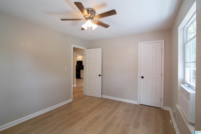 unfurnished bedroom with baseboards, light wood-style flooring, and a ceiling fan