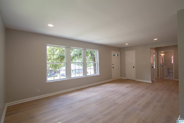unfurnished room featuring recessed lighting, light wood-style floors, and baseboards