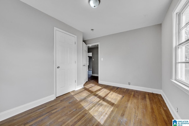 unfurnished bedroom featuring hardwood / wood-style flooring