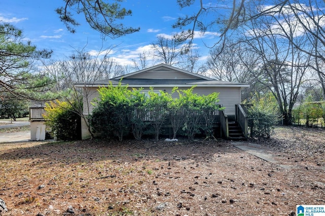 view of side of home with a deck