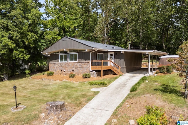 view of front of property with a front yard and a carport