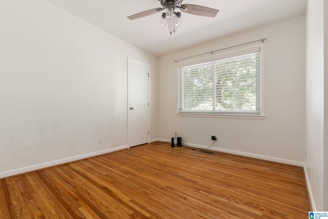 spare room with hardwood / wood-style flooring and ceiling fan