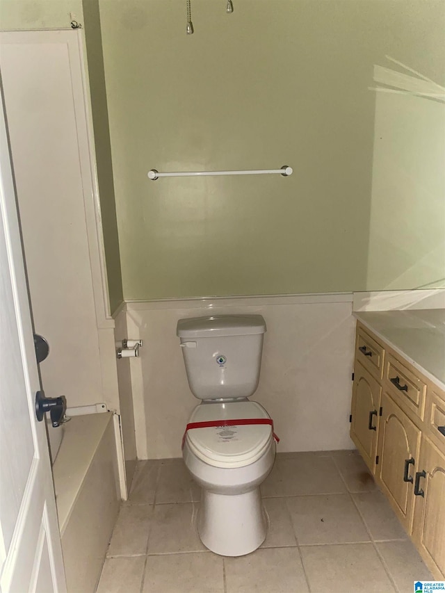 bathroom featuring tile patterned floors, toilet, and vanity