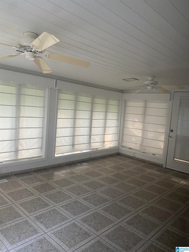 unfurnished sunroom featuring ceiling fan