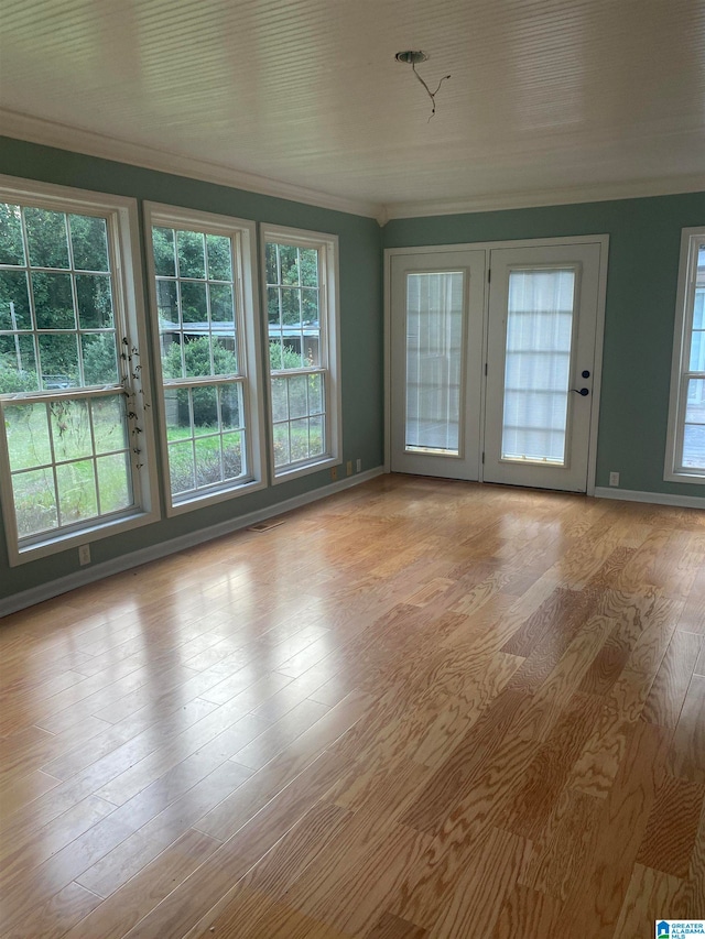 unfurnished room with light wood-type flooring and ornamental molding