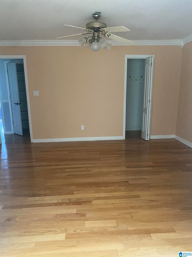 empty room featuring crown molding, ceiling fan, and light hardwood / wood-style floors