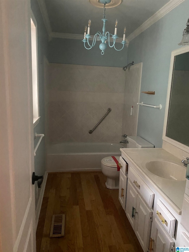 full bathroom with vanity, toilet, tiled shower / bath combo, and hardwood / wood-style floors