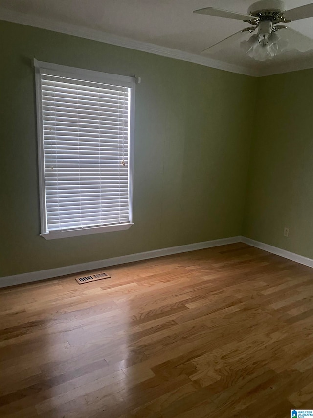 unfurnished room with ceiling fan, hardwood / wood-style flooring, and crown molding